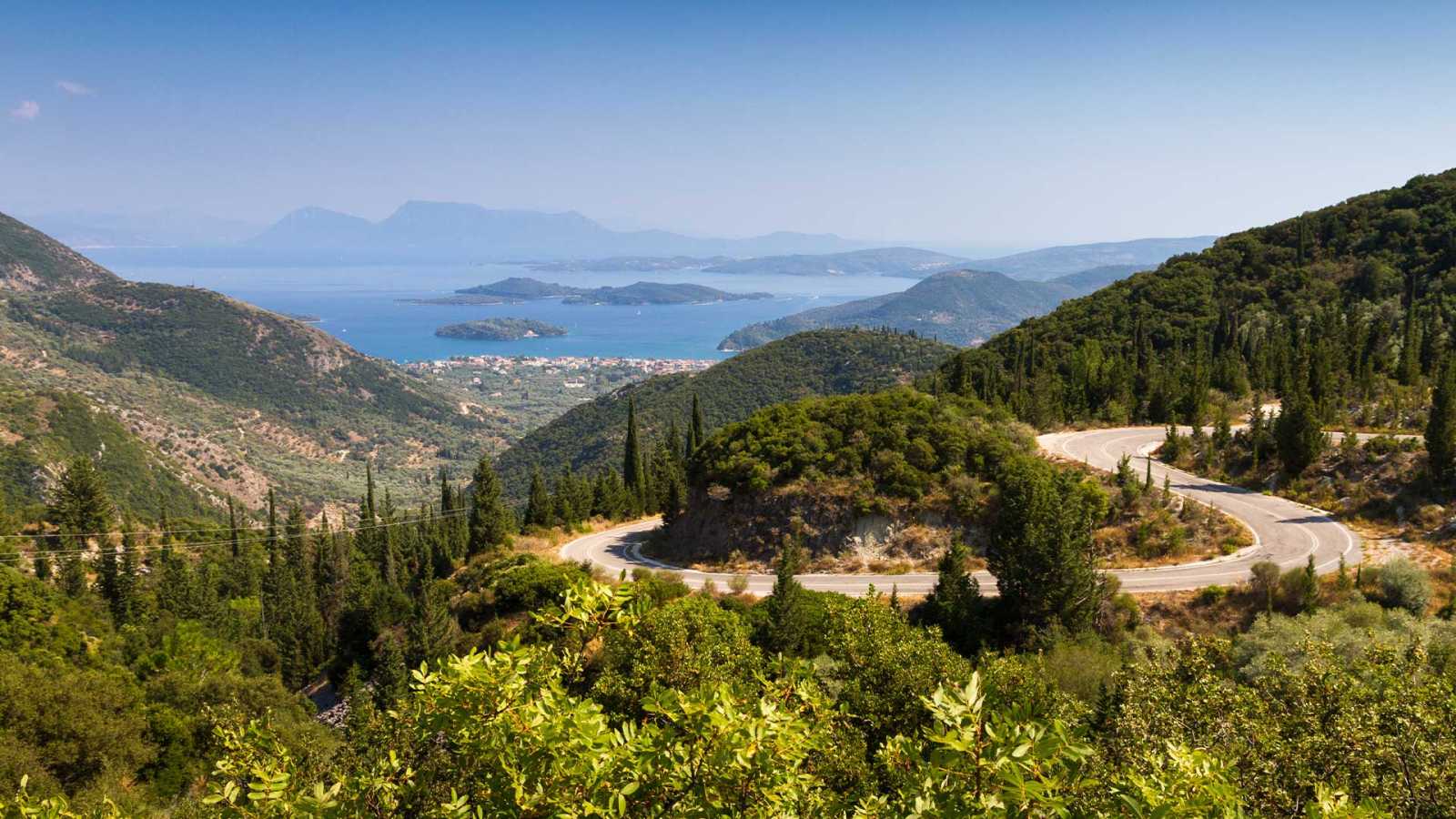A panoramic view of hills and beachfront in Lefkada, illustrating the kinds of landscapes you can expect when following our Guide To Buying Land In Lefkada.