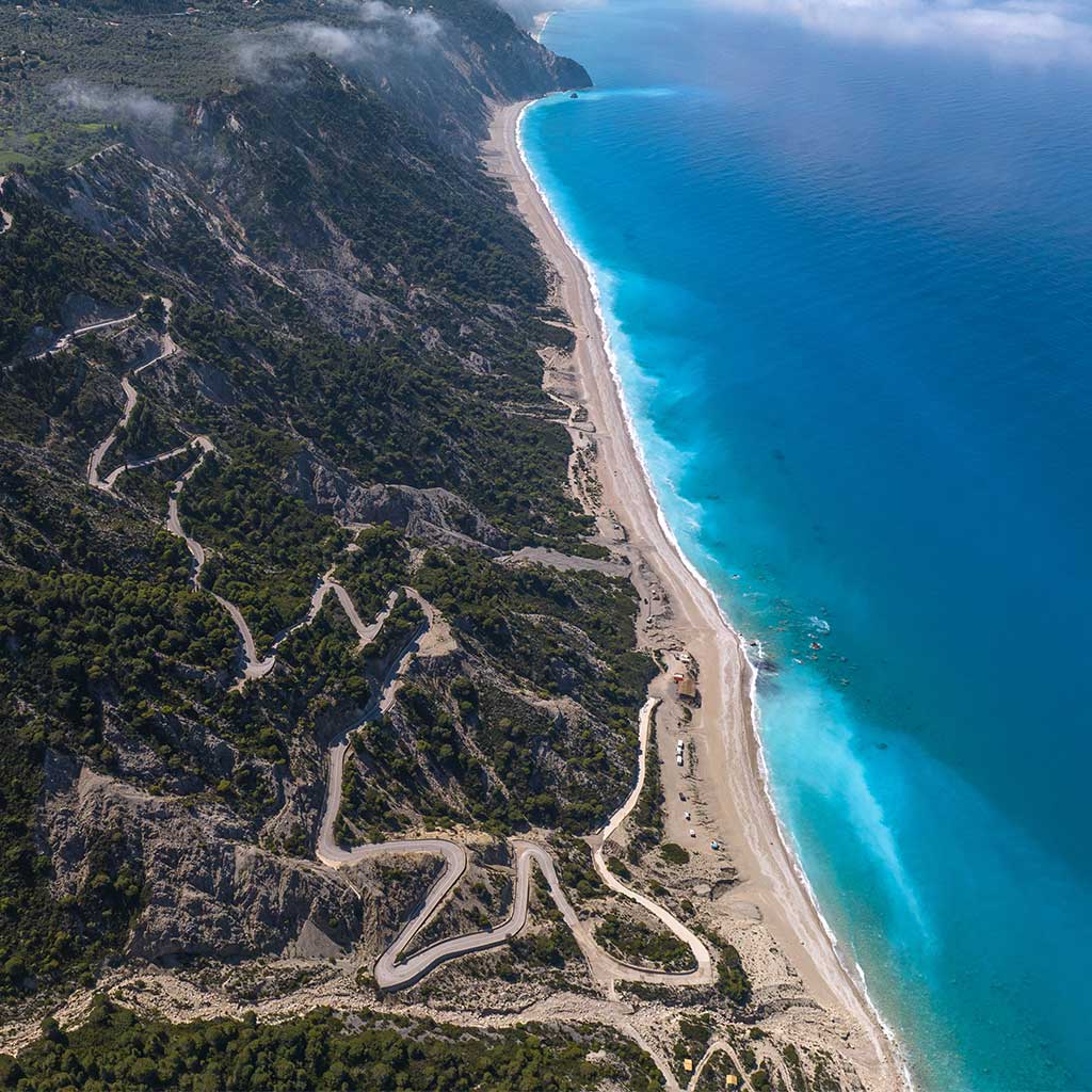 Drone shot of scenic land by the beach and mountain in Porto Katsiki, offered by Porto Katsiki Lefkada Real Estate