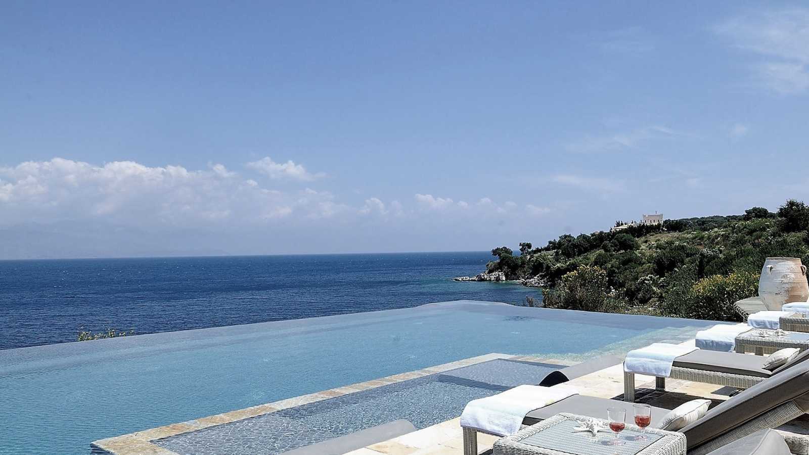 A luxurious villa located on prime beachfront land in Kalamitsi, illustrating the ideal investment opportunity.