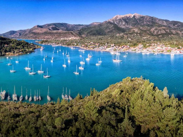 Arial view of Nydri Bay in Lefkada, showcasing the beautiful landscape. Explore opportunities to buy land in Lefkada with breathtaking views.