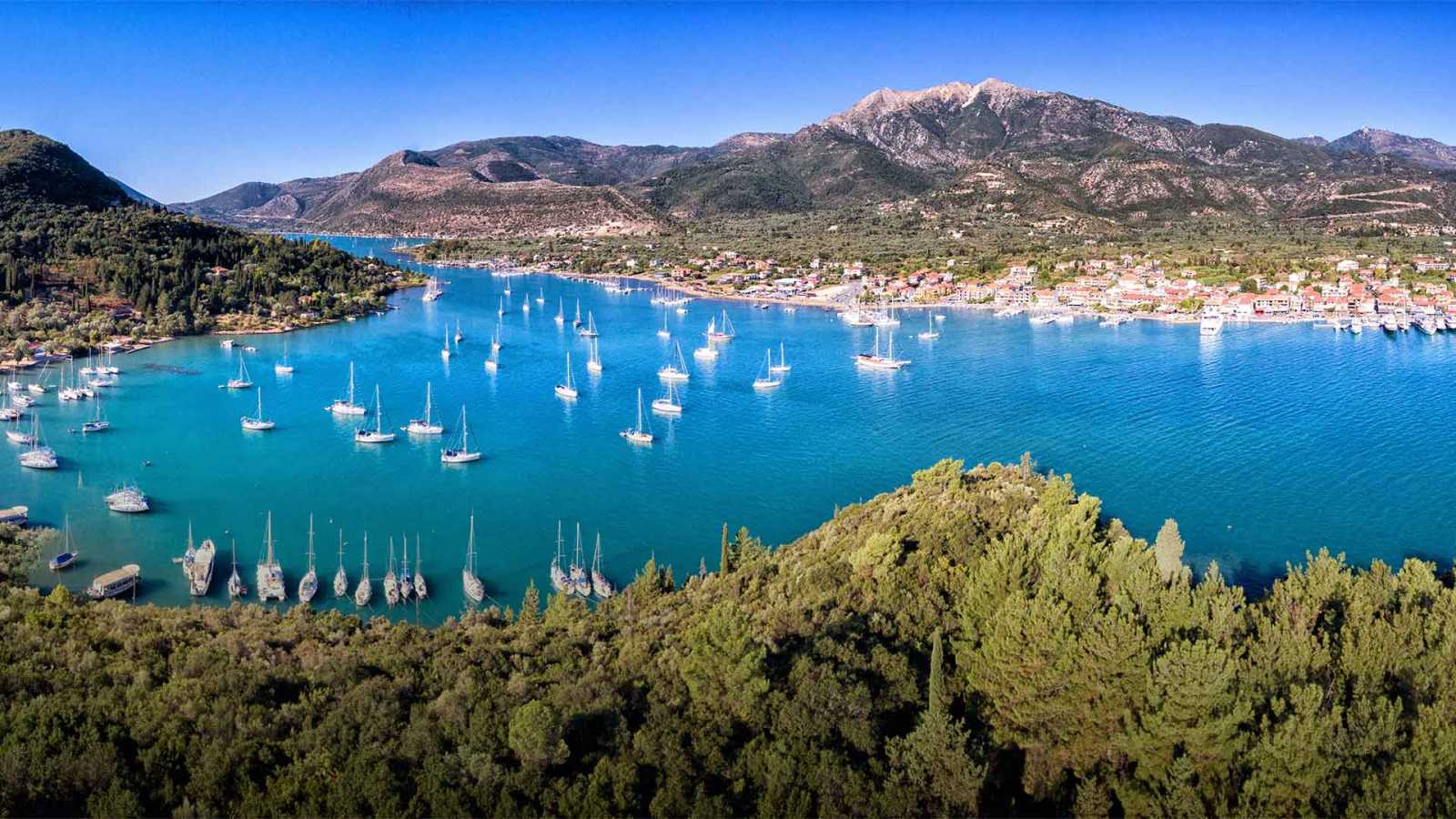 Arial view of Nydri Bay in Lefkada, showcasing the beautiful landscape. Explore opportunities to buy land in Lefkada with breathtaking views.