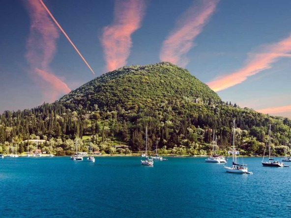 Scenic view of Lefkada beach near Nydri with boats - consider to buy property in Lefkada.