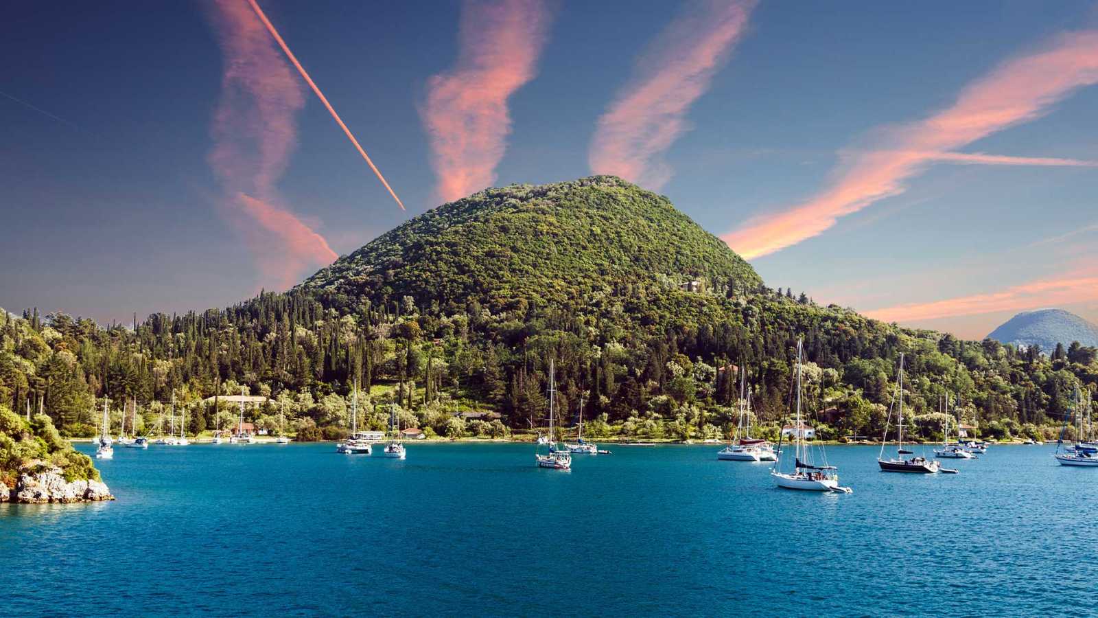 Scenic view of Lefkada beach near Nydri with boats - consider to buy property in Lefkada.