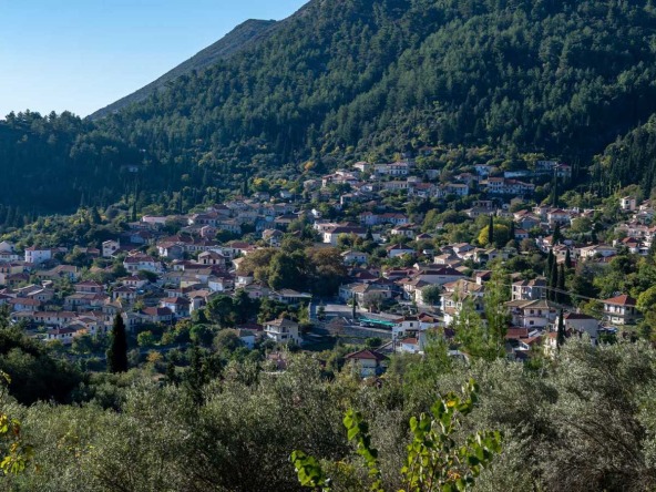 An aerial view of the picturesque Karya village in Lefkada, showcasing available land for sale in Karya amidst lush landscapes and traditional Greek architecture.