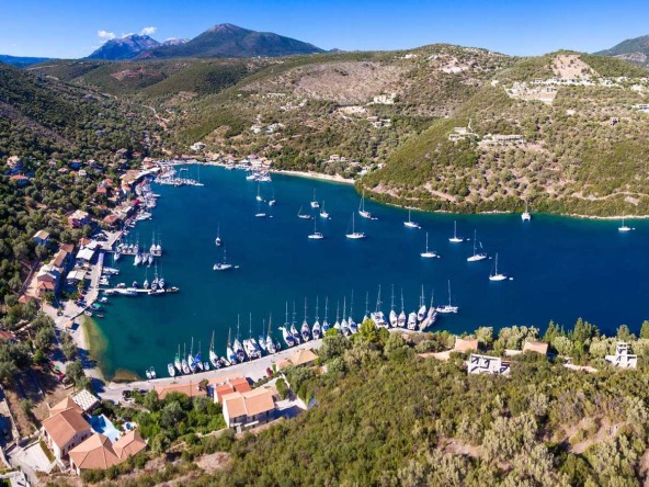 An aerial view of the picturesque village of Sivota, showcasing available plots of land amidst the lush landscape, perfect for those seeking land for sale in Sivota.