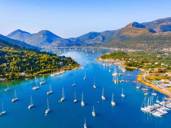 Serene Nydri beach in Lefkada with boats, ideal land for sale Lefkada